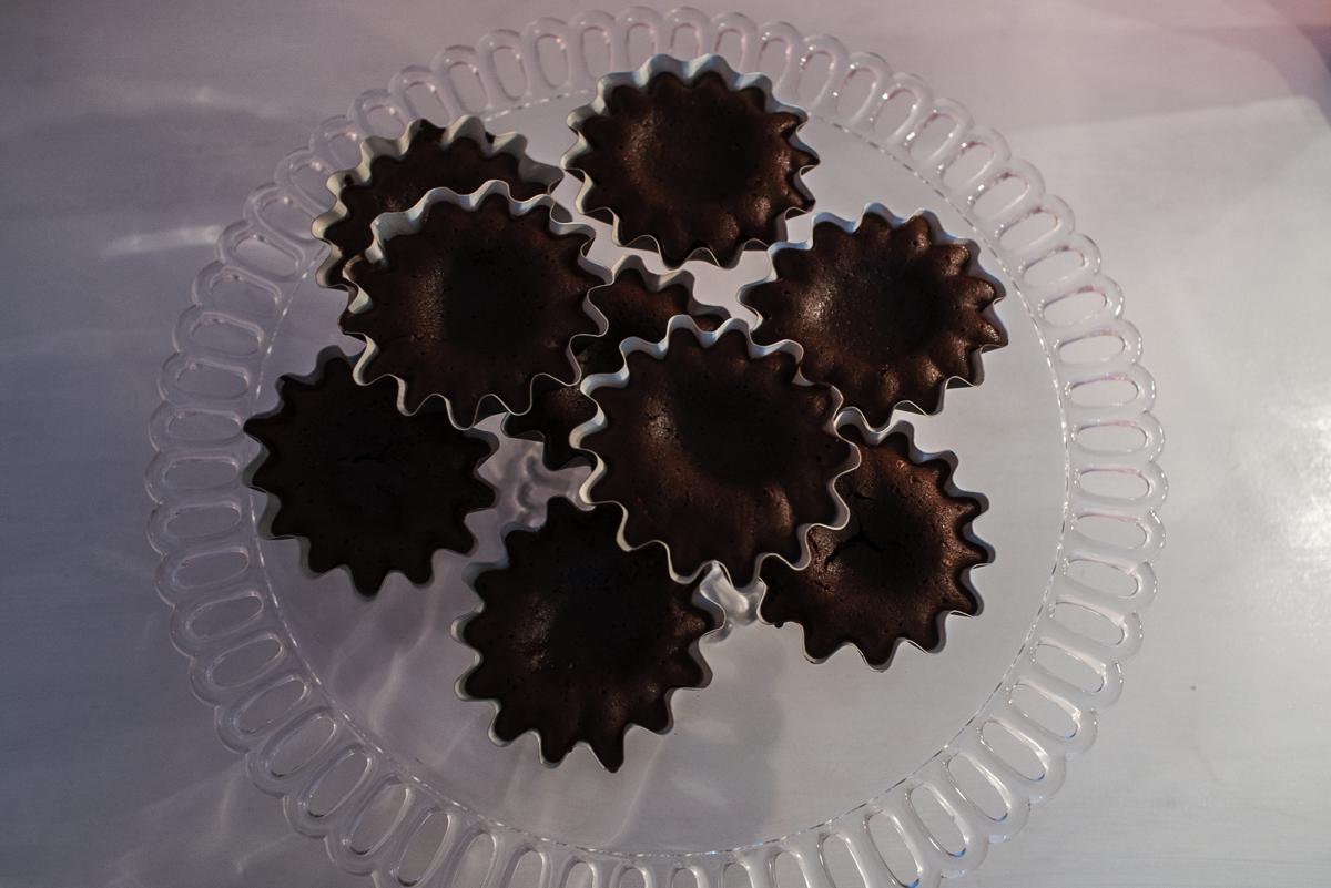 Tortine di cioccolato fondente disposte su un'alzata di vetro lavorato